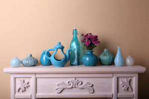 fireplace with blue glasses and vases on mantel