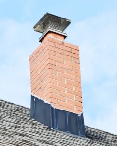 masonry chimney with proper flashing, crown and cap