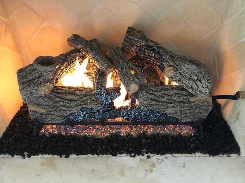 Gas Logs Charred Oak fire with fire brick background.