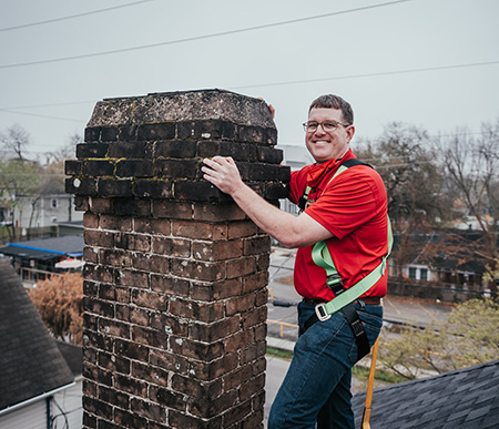 Lee standing on roof touching chimney - Lords Chimney