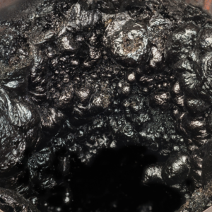 an up-close shot of black gooey creosote