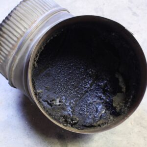 dark creosote in a metal chimney pipe