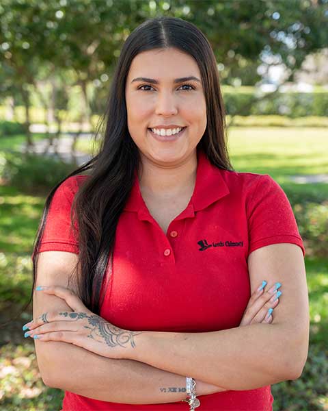 Office Team - Milly Marrero has nice smile wearing red logo shirt.